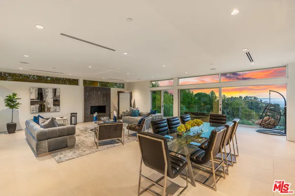 a living room with furniture city view and large windows