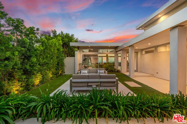 a house view with a sitting space and garden space