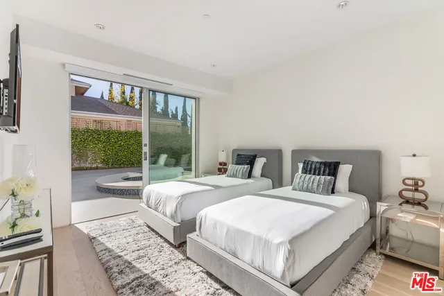 a bedroom with double bed and a large window