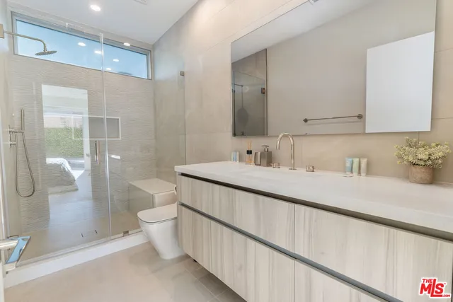 a bathroom with a double vanity sink mirror and toilet