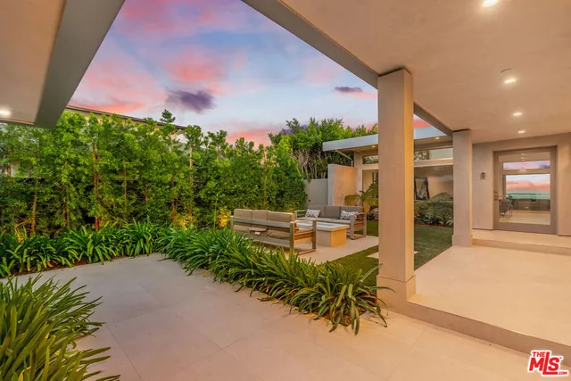 a view of a patio with table and chairs and potted plants