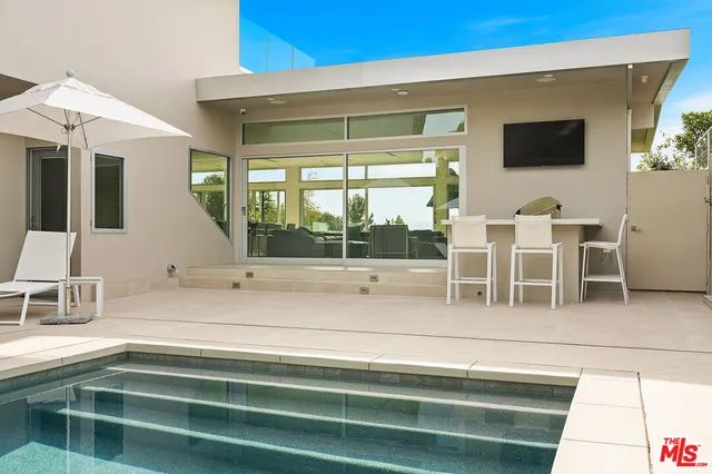 a view of a chair and tables in the balcony
