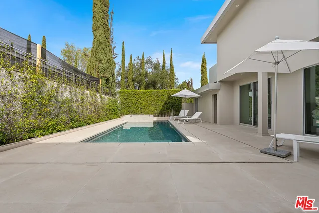 a view of a patio with table and chairs and potted plants