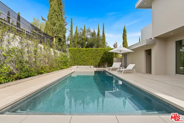 a view of a patio with table and chairs and potted plants