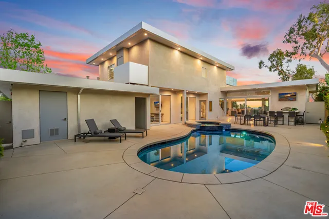 a view of a house with pool and chairs