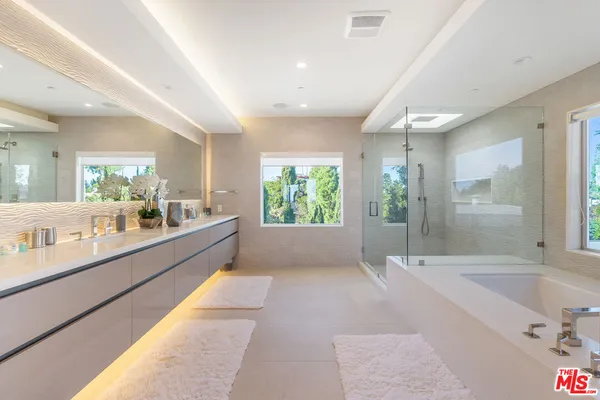a large bathroom with a large tub and shower