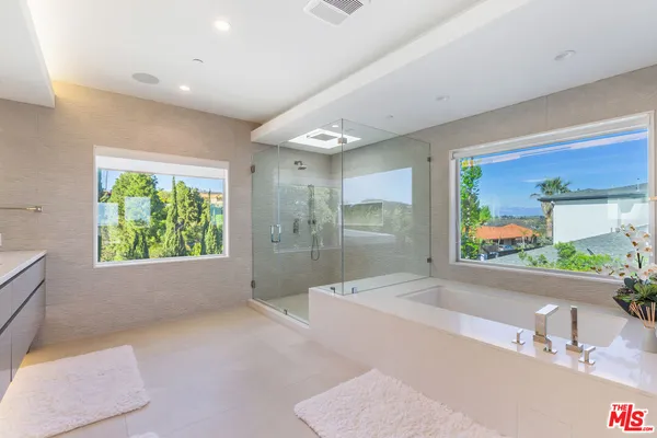a bathroom with a tub and a sink