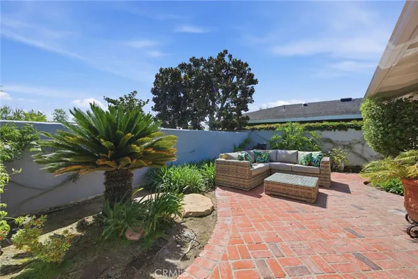 a view of a patio with table and chairs and potted plants