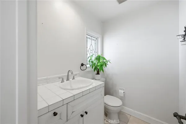 a bathroom with a double vanity sink a toilet and a shower
