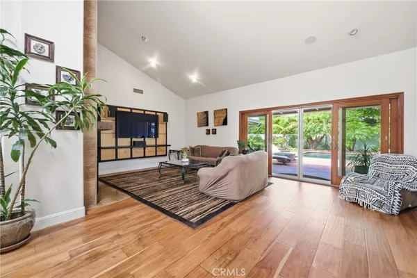 a vase of flowers sitting on a table with a living room