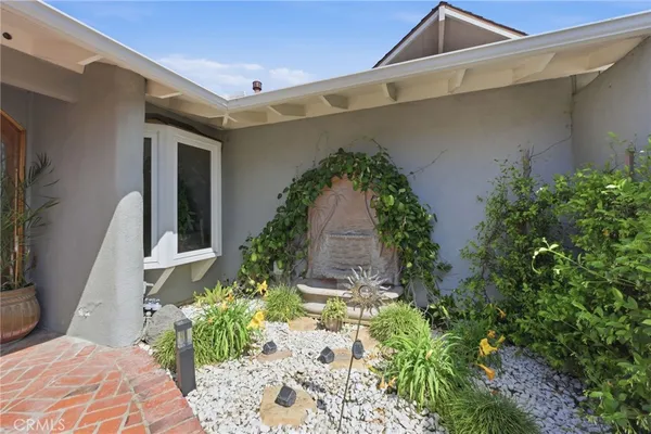 a view of a backyard with garden and plants