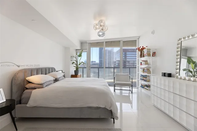 a bedroom with a bed a table and chair