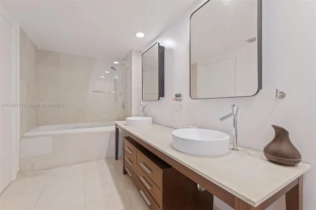 a bathroom with a sink double vanity and tub