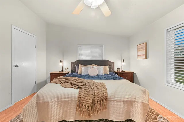 a bedroom with a bed and a window