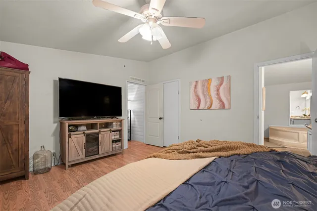 a bedroom with a bed and a flat screen tv