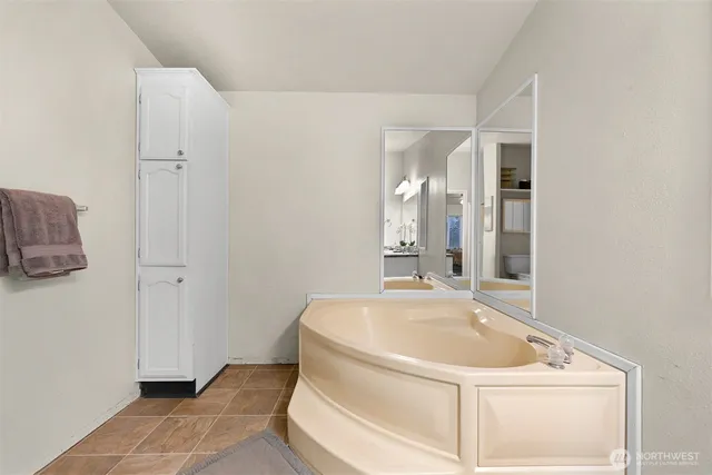 a bathroom with a tub and sink