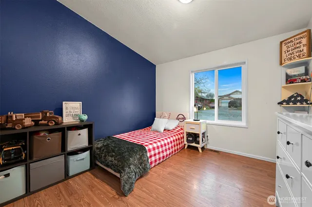 a bedroom with a bed and a window