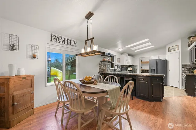 a view of a dining room with furniture wooden floor and a chandelier