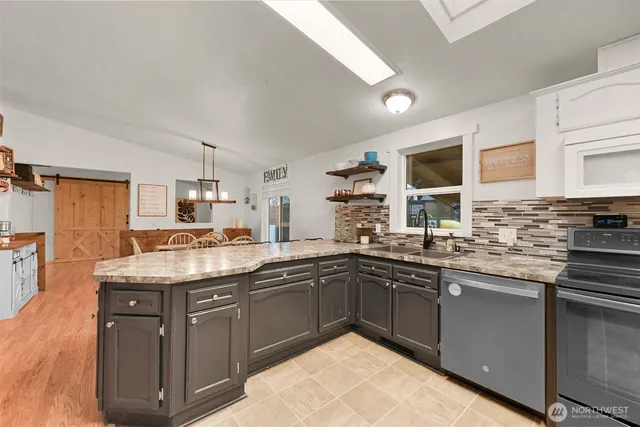 a kitchen with a sink stove and cabinets