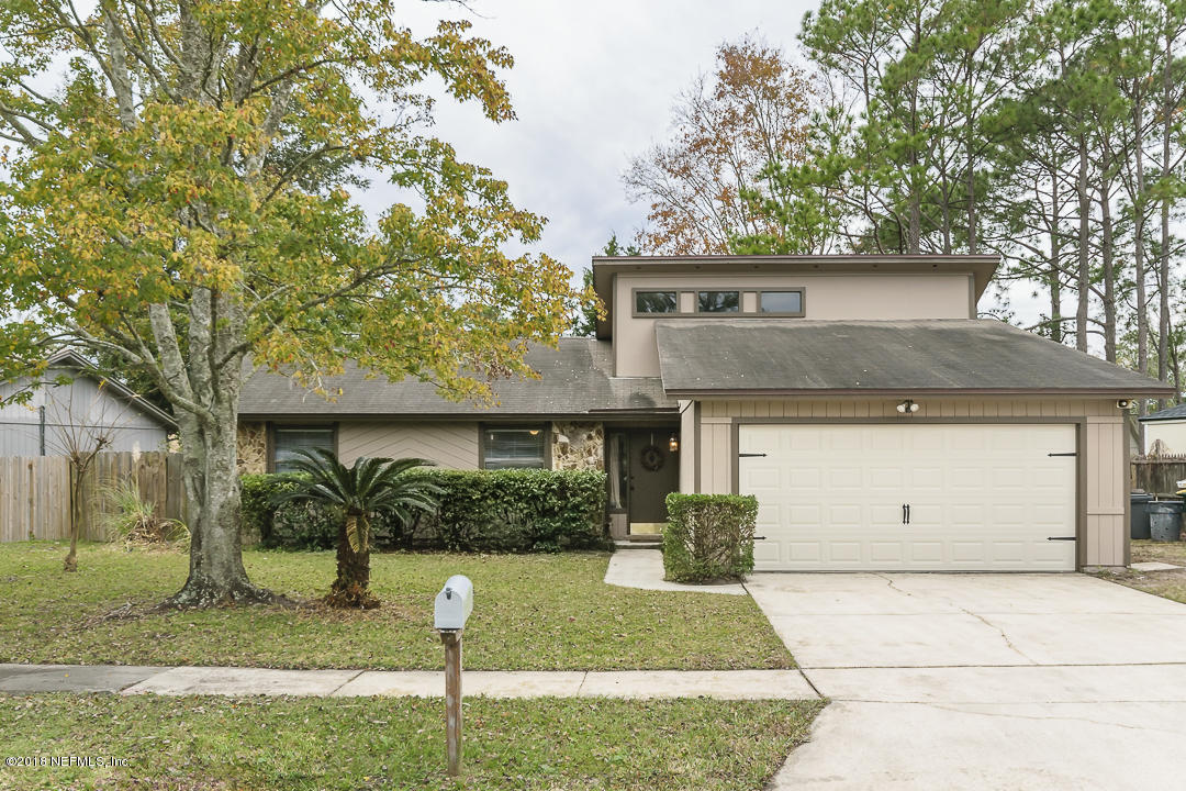 2526 Wattle Tree Road West Jacksonville, FL 32246 - Photo 1 of 19 a front view of a house with a garden