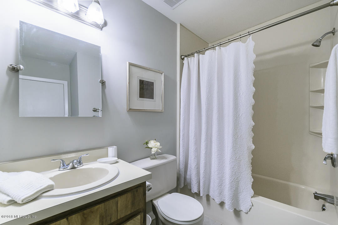 2526 Wattle Tree Road West Jacksonville, FL 32246 - Photo 14 of 19 a bathroom with a sink a toilet and shower curtain