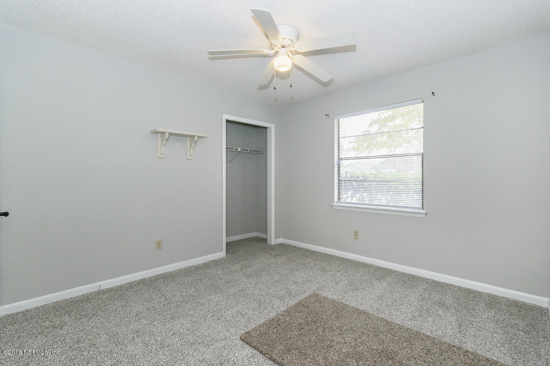 2526 Wattle Tree Road West Jacksonville, FL 32246 - Photo 17 of 19 an empty room with windows and fan