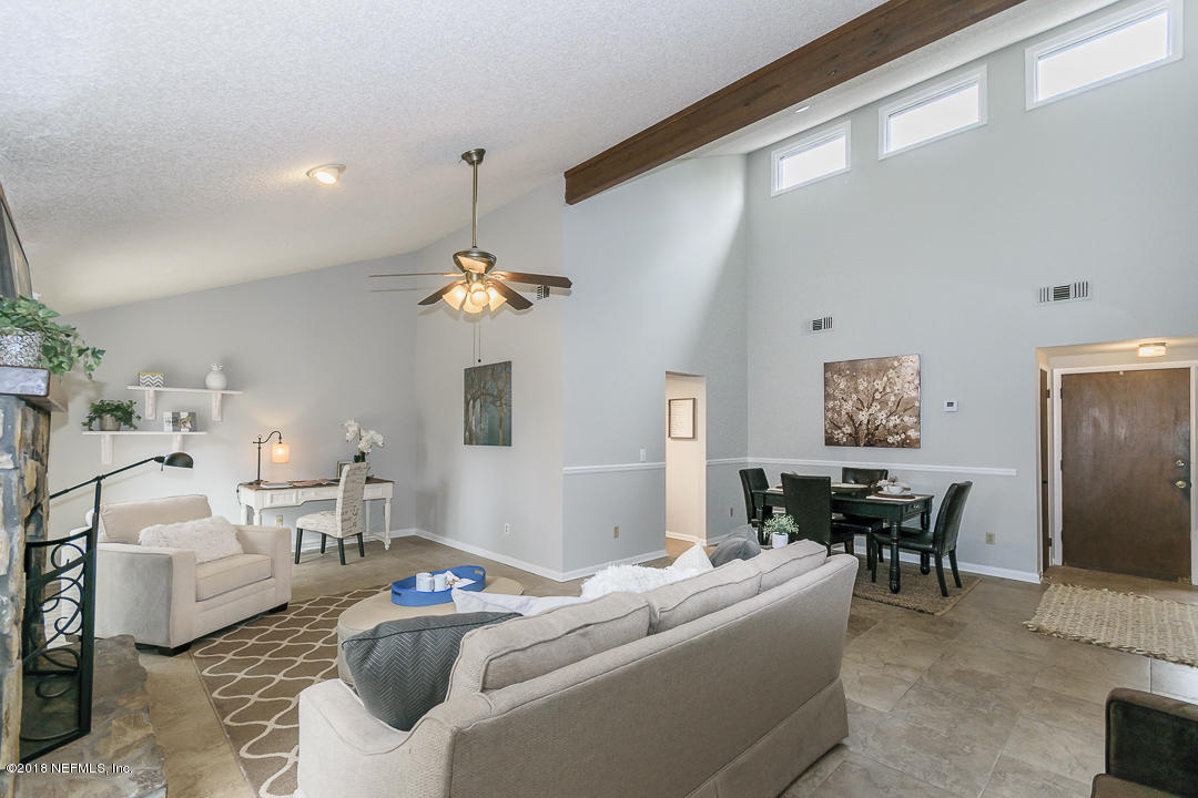 2526 Wattle Tree Road West Jacksonville, FL 32246 - Photo 6 of 19 a living room with furniture a dining table and a window