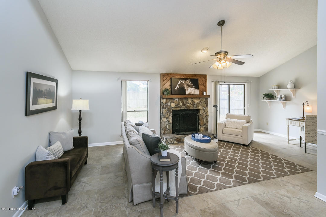 2526 Wattle Tree Road West Jacksonville, FL 32246 - Photo 7 of 19 a living room with fireplace furniture and a wooden floor