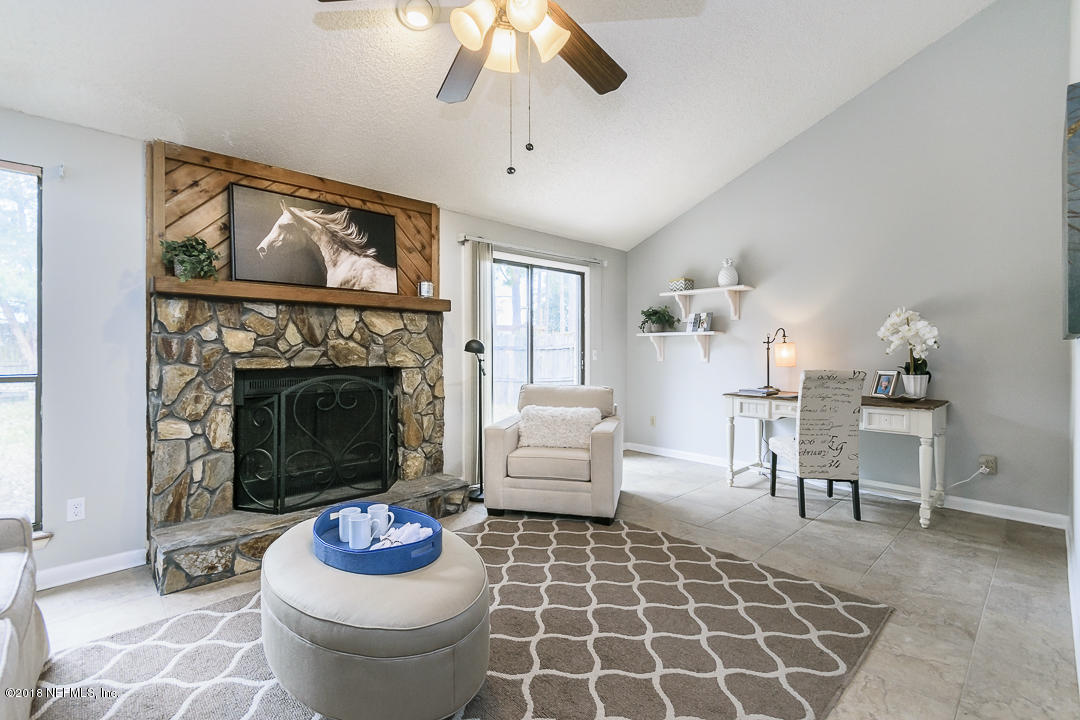 2526 Wattle Tree Road West Jacksonville, FL 32246 - Photo 8 of 19 a living room with furniture a rug and a fireplace