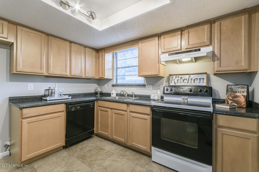 2526 Wattle Tree Road West Jacksonville, FL 32246 - Photo 10 of 19 a kitchen with stainless steel appliances granite countertop a sink stove and cabinets