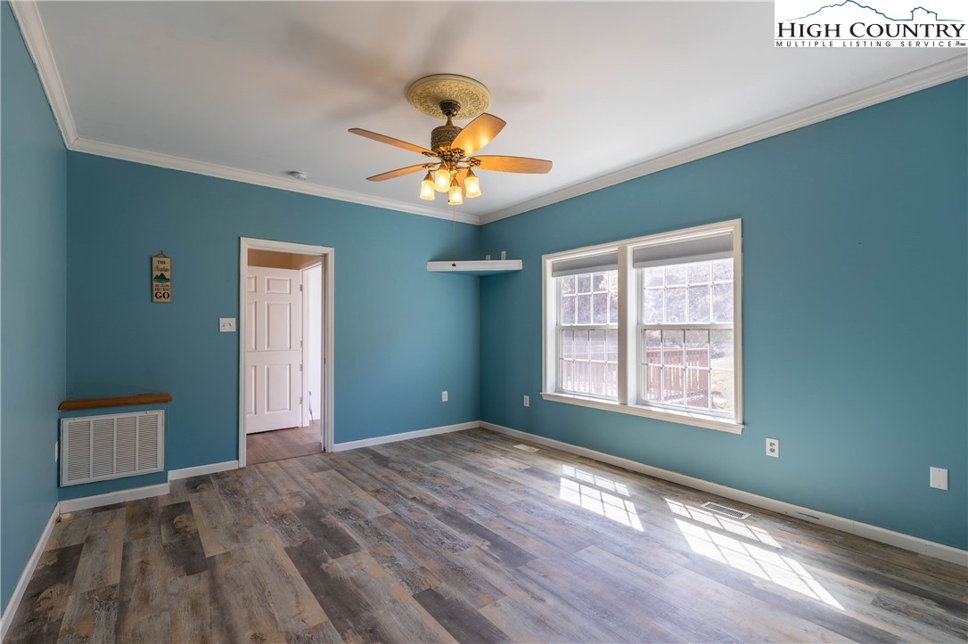449 Meadow Ridge Drive Jefferson, NC 28640 - Photo 12 of 37 a view of an empty room with window and wooden floor