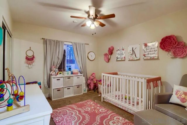 a bedroom with furniture and a baby crib