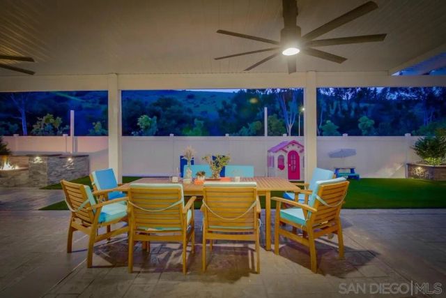 a dining room with furniture and a floor to ceiling window