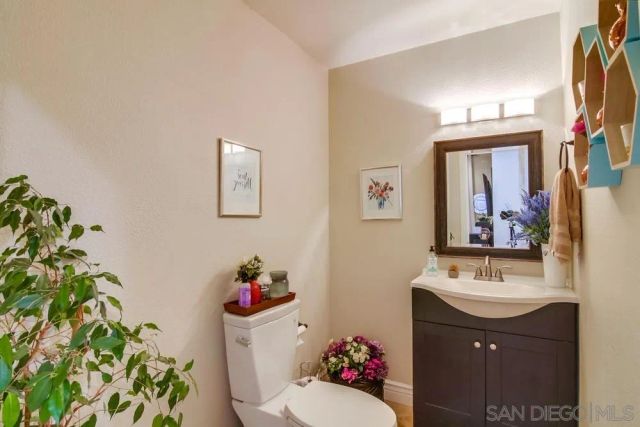 a bathroom with a sink mirror and vanity