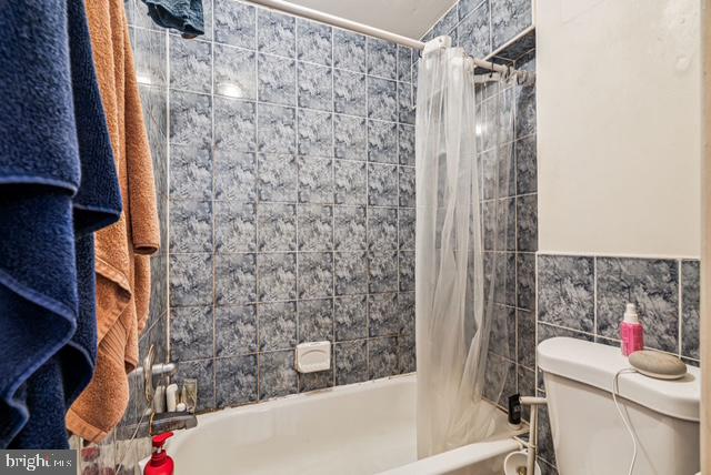 1917 Spring Garden Street, Unit 1 Philadelphia, PA 19130 - Photo 3 of 5 a bathroom with a bathtub and toilet