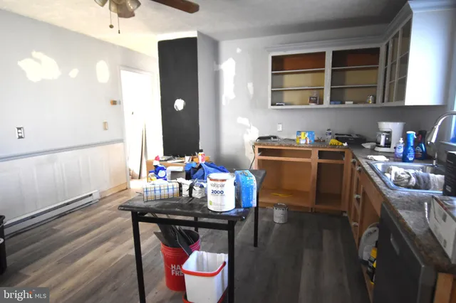 a kitchen with a table chairs stove and cabinets