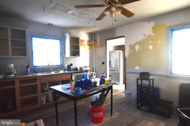 a kitchen with a dining table chairs sink and granite counter top