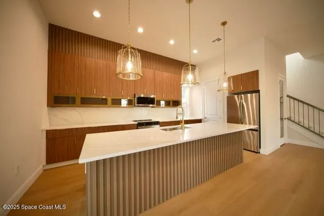 a view of a kitchen with a sink and a refrigerator