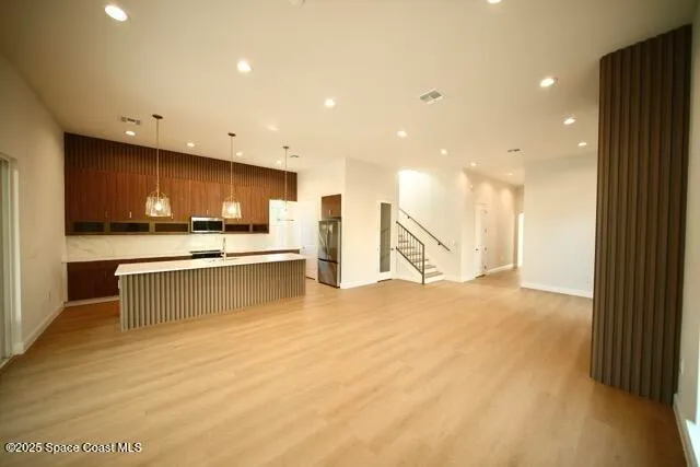 a living room with furniture a flat screen tv and a large window