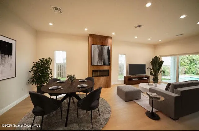 an empty room with windows and fireplace