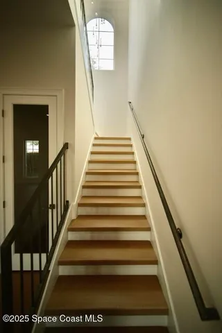 a view of entryway with stairs and wooden floor