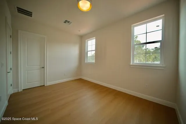 a spacious bathroom with a shower a sink and a mirror