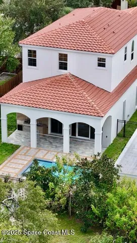 a front view of a house with a yard and potted plants