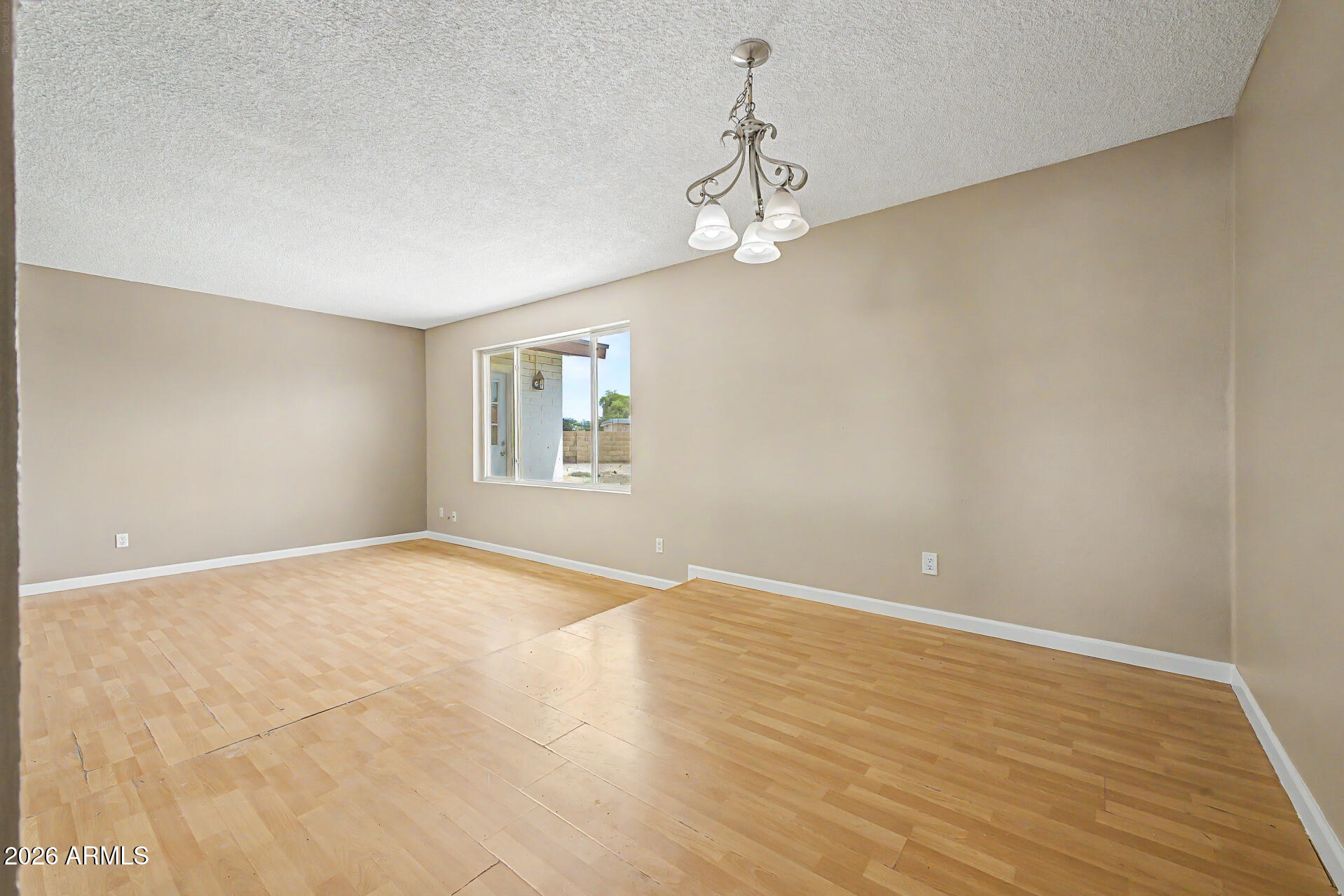 4007 West Mountain View Road Phoenix, AZ 85051 - Photo 9 of 31 a view of empty room with wooden floor and fan