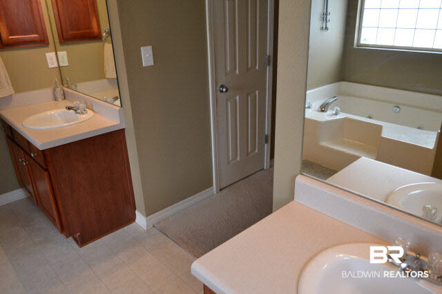 12191 Verona Court Foley, AL 36535 - Photo 11 of 21 The master bath has double vanities. Double walk-in closets are located between the bedroom and bath