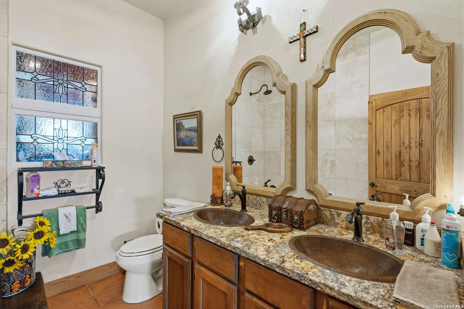 1150 Bruce Road Poteet, TX 78065 - Photo 18 of 33 a bathroom with a granite countertop toilet a sink and a mirror