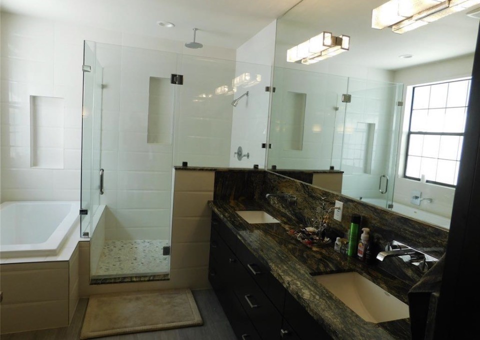 4506 Austin Street, Unit A Houston, TX 77004 - Photo 12 of 12 a bathroom with a sink vanity granite tub and shower