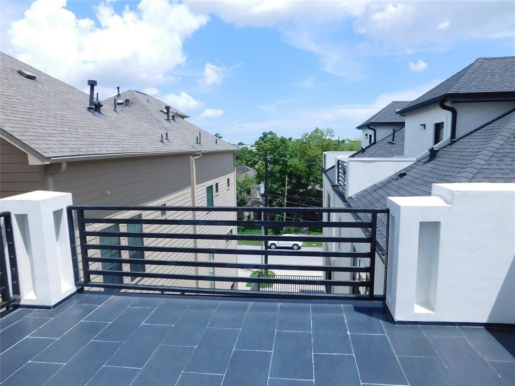 4506 Austin Street, Unit A Houston, TX 77004 - Photo 2 of 12 a view of a house with a small yard and large trees
