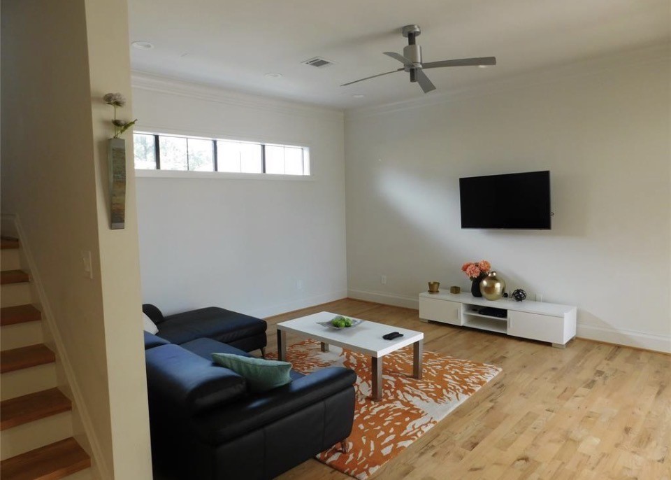 4506 Austin Street, Unit A Houston, TX 77004 - Photo 5 of 12 a living room with furniture and a flat screen tv
