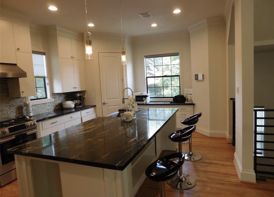 4506 Austin Street, Unit A Houston, TX 77004 - Photo 7 of 12 a kitchen with granite countertop a sink a stove and a refrigerator